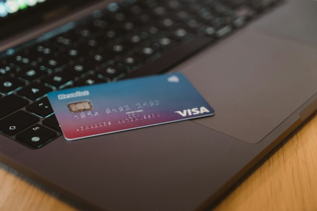 A debit card resting on a laptop keyboard