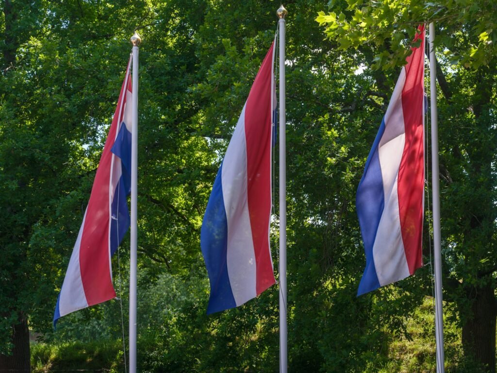 Three Dutch flags flying