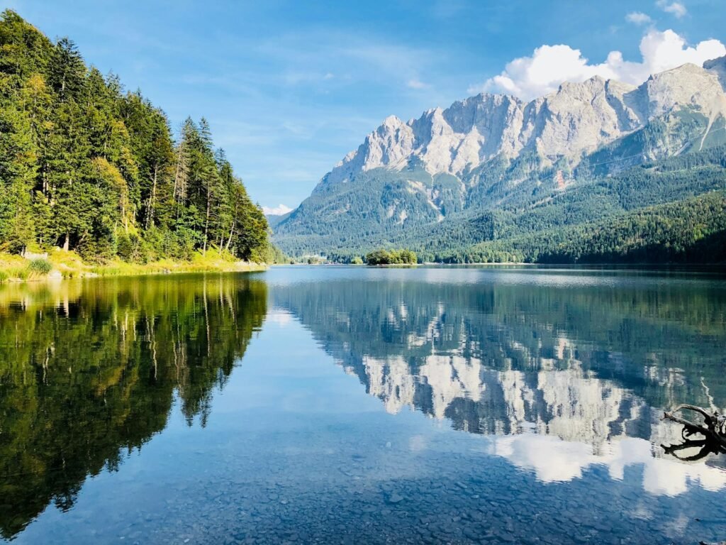 The Zugspitze reflected in the clear water of the Eibsee in the Bavarian Alps