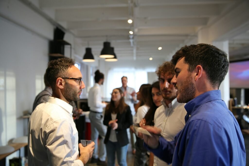 A group of people talking at an indoor event