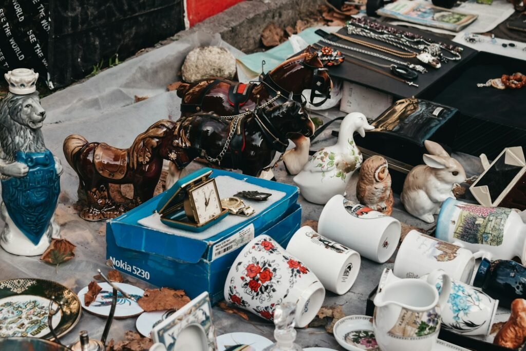 Vintage ceramics, clocks and bric-a-brac on a table at a flea market in the Netherlands
