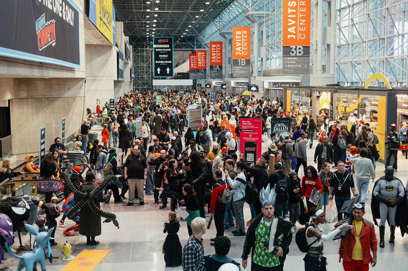 Crowd of visitors walking through a comic convention hall