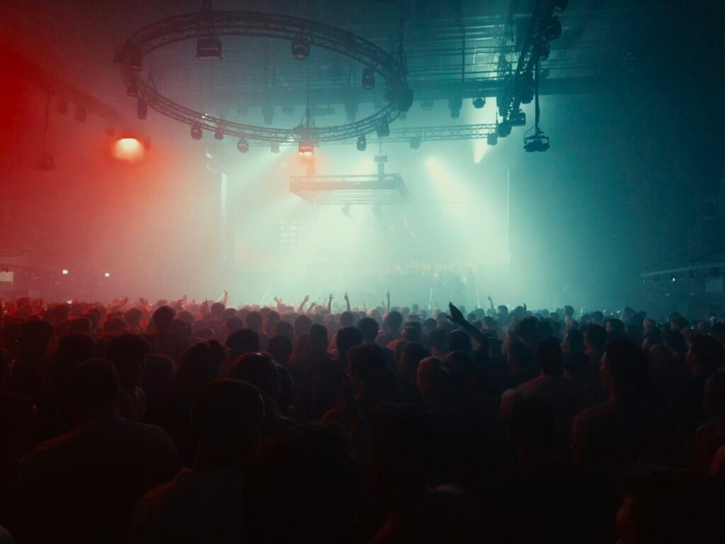 Stage lights over a large concert crowd