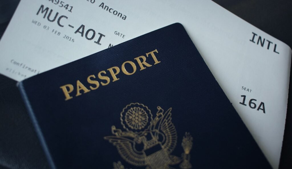 Passport on top of paperwork for a visa application