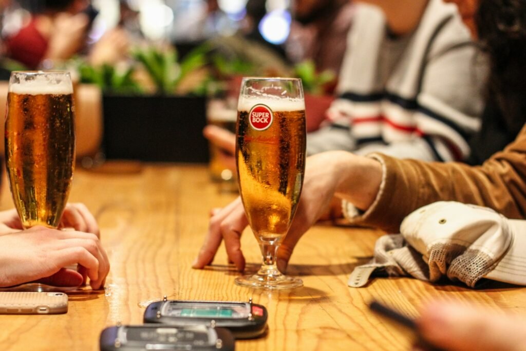 Glass of dark beer on a wooden table