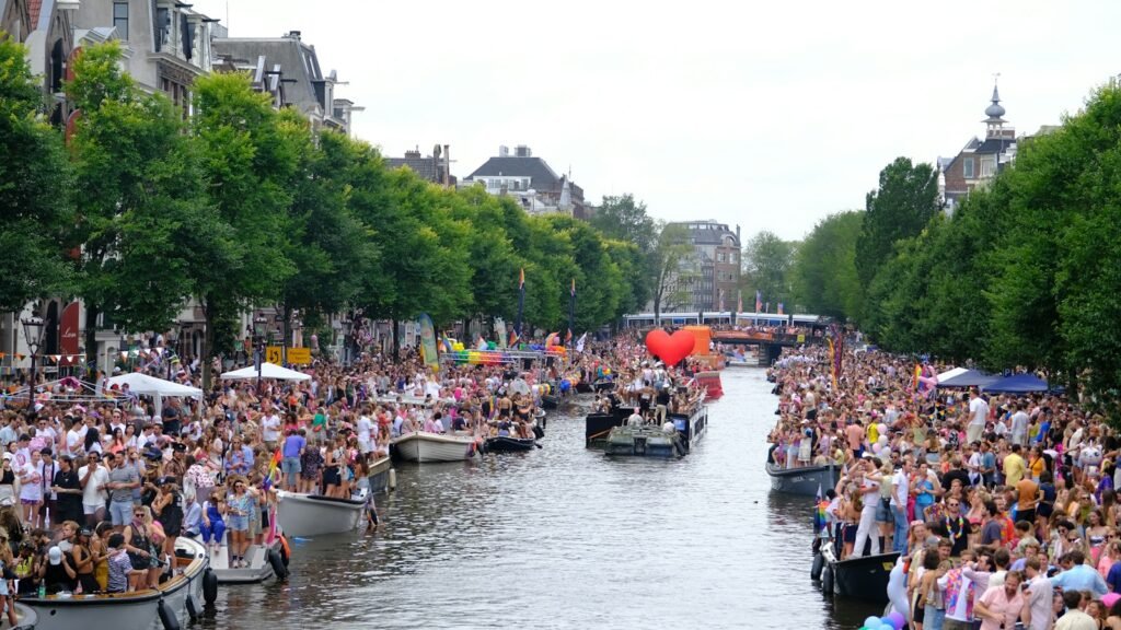Boats full of people on an Amsterdam canal