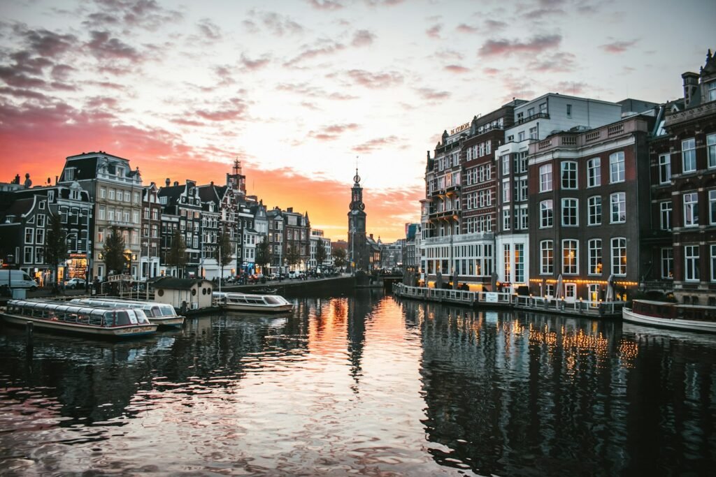 A boat on a canal between Dutch canal houses