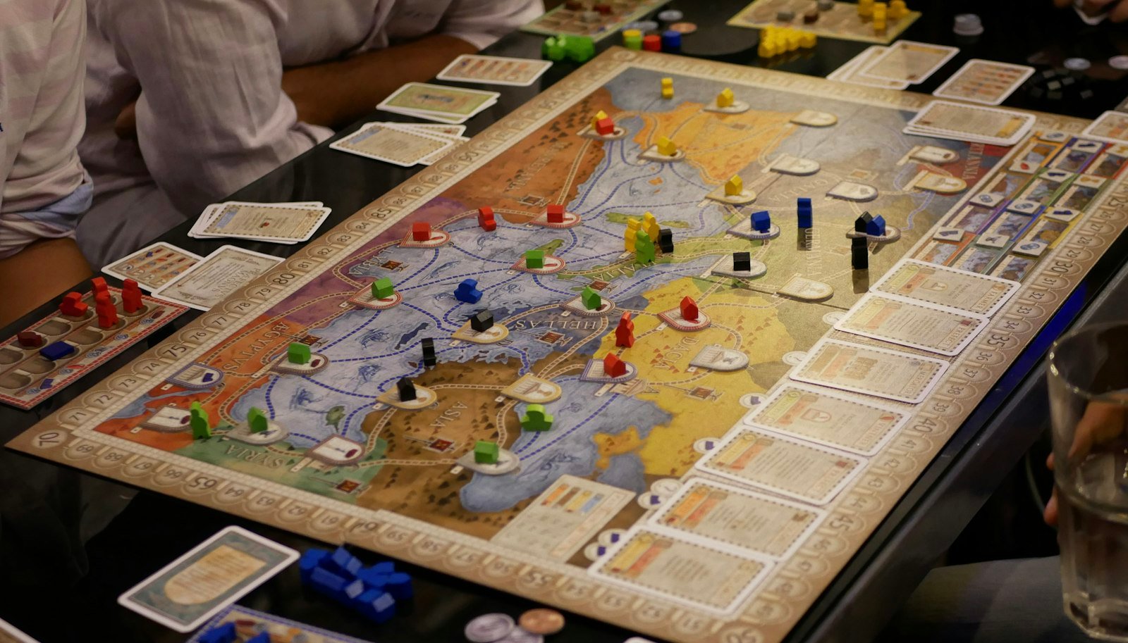 Person playing a board game at a table