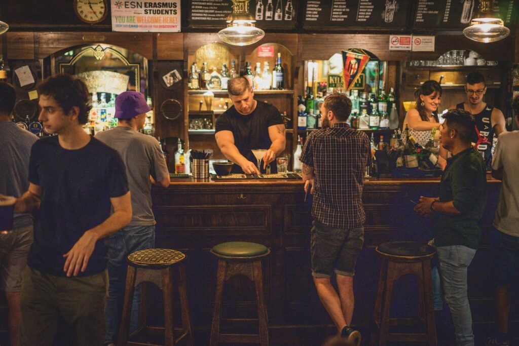 Group of people standing around a bar