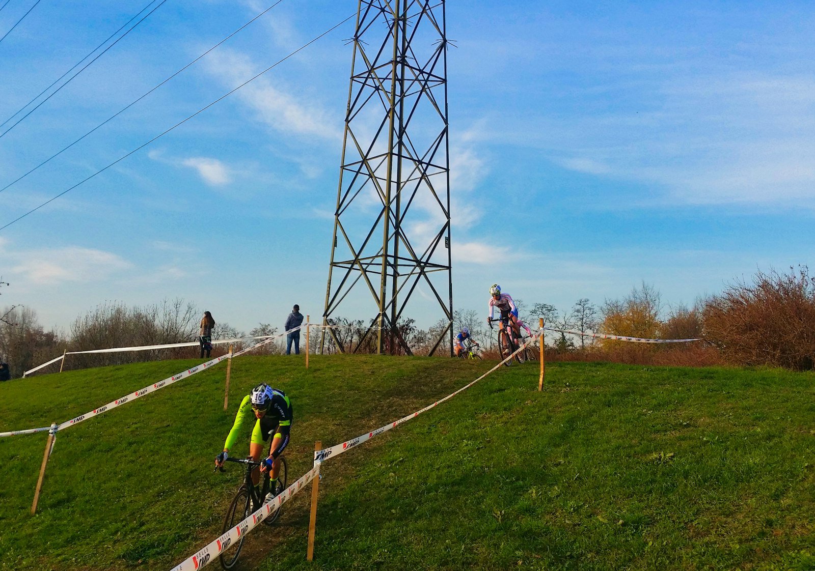 Cyclists racing up a grassy hill