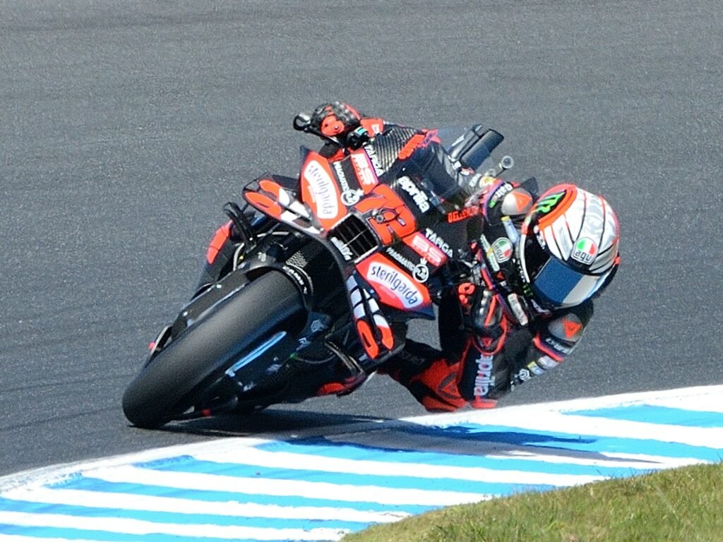 Motorcyclist leaning into a turn on a race track