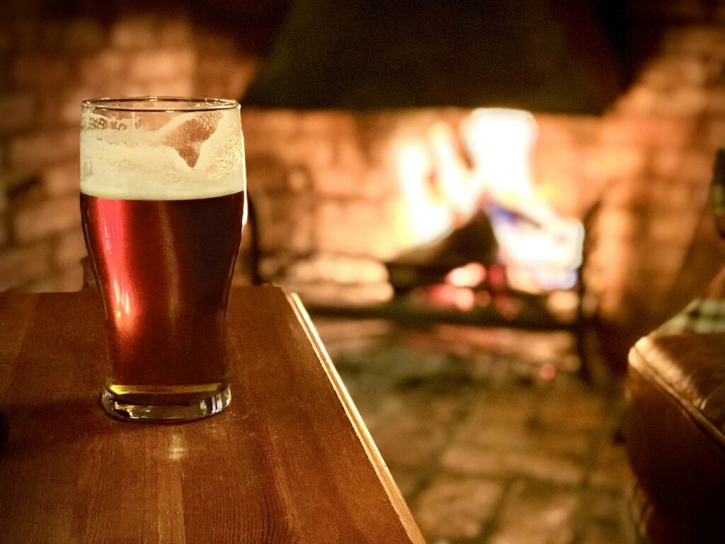 Glass of dark beer on a wooden table