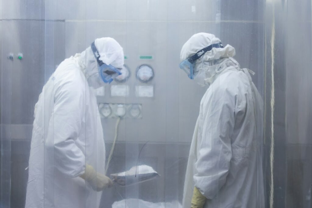 Two scientists in protective suits working in a high security laboratory