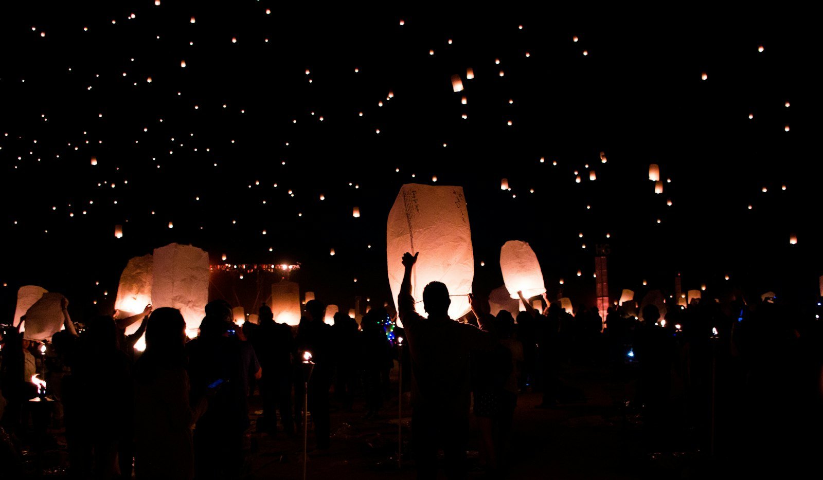 People holding lanterns at night