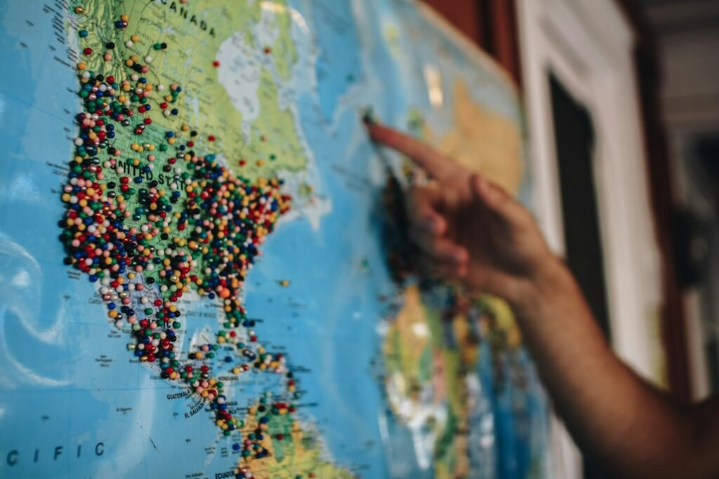 Pointing at a world map with pins