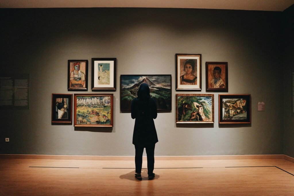 Visitor in front of paintings