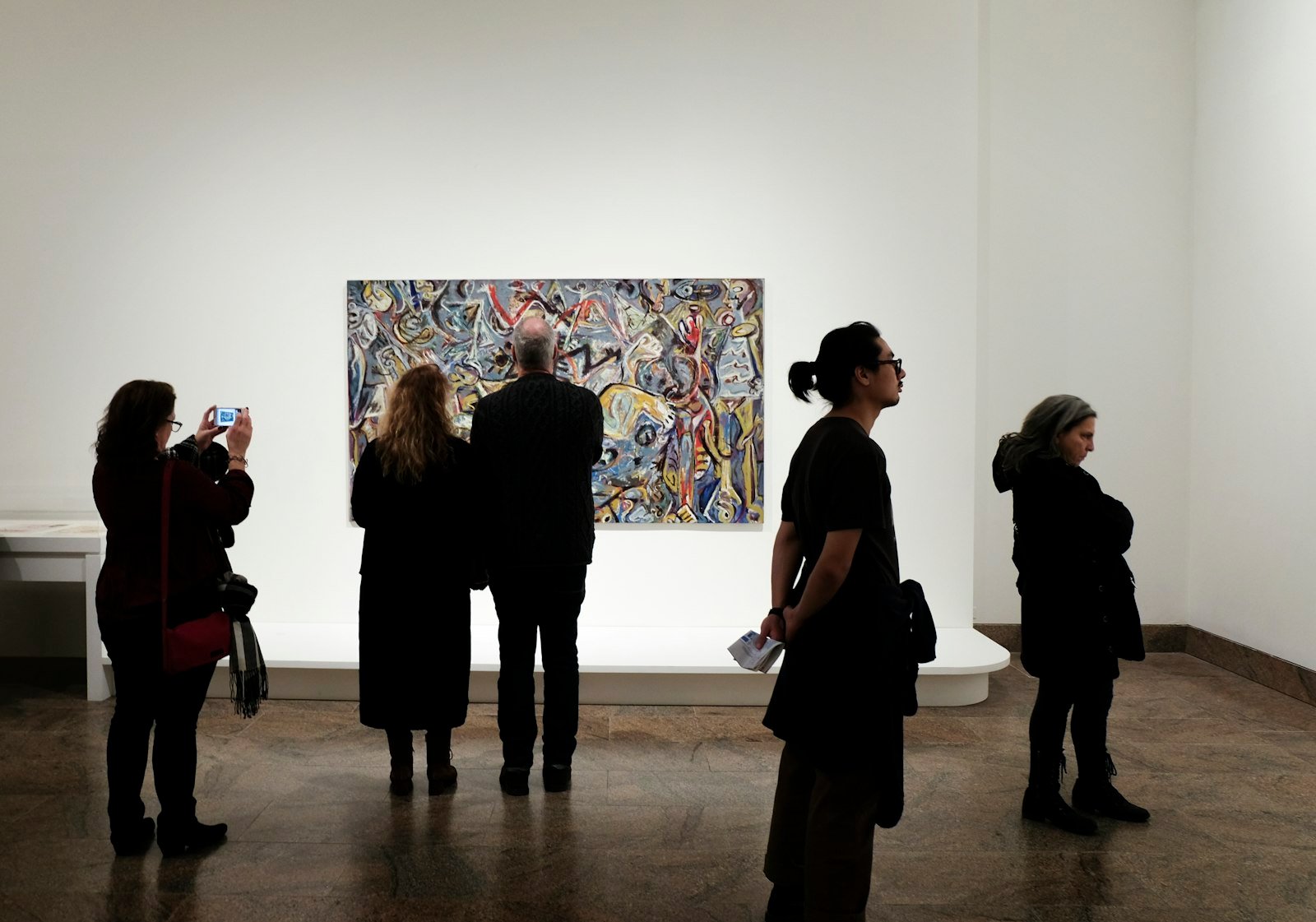 People in front of a painting