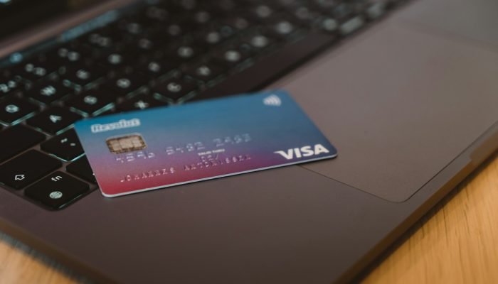 A debit card resting on a laptop keyboard