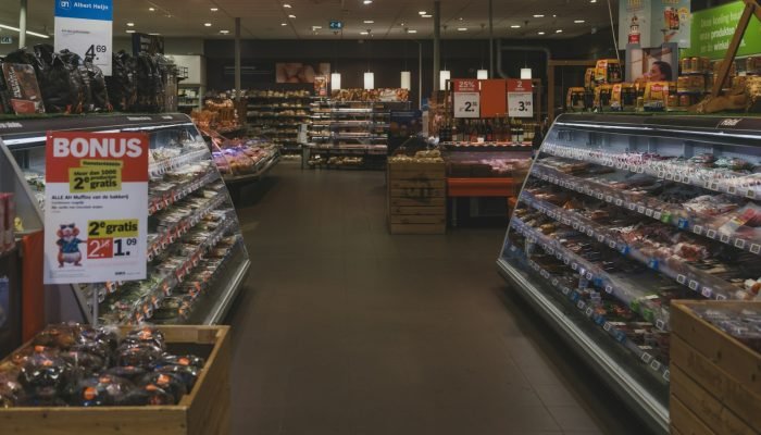 A supermarket aisle with refrigerated food displays