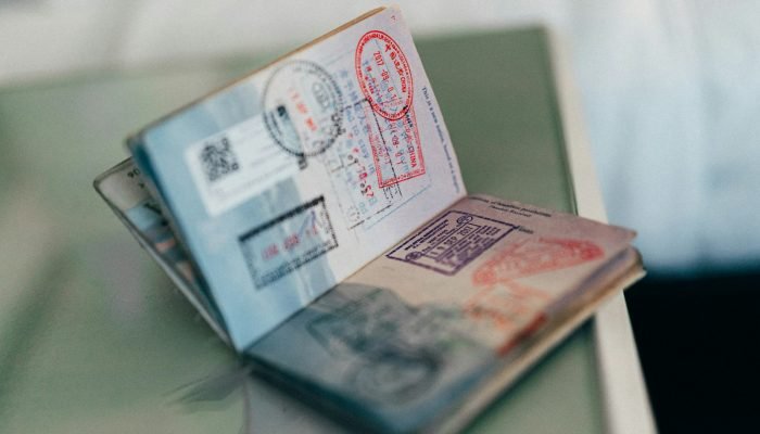 An open passport with stamps