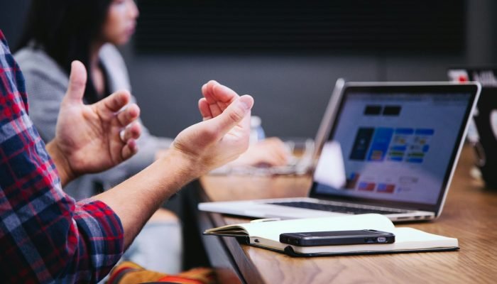 People in a meeting with a laptop