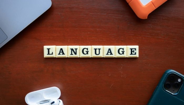 Scrabble tiles spelling the word language on a table