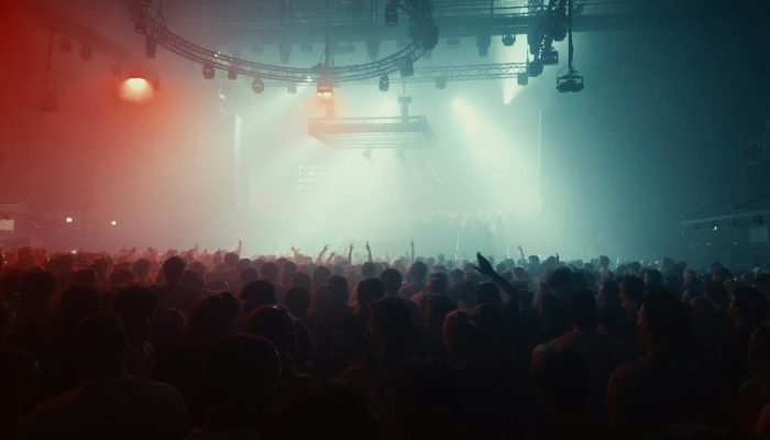 Stage lights over a large concert crowd