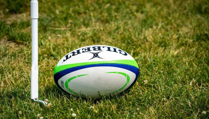 Rugby ball on a green rugby field