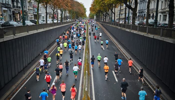 A large group of runners on a road during a running event