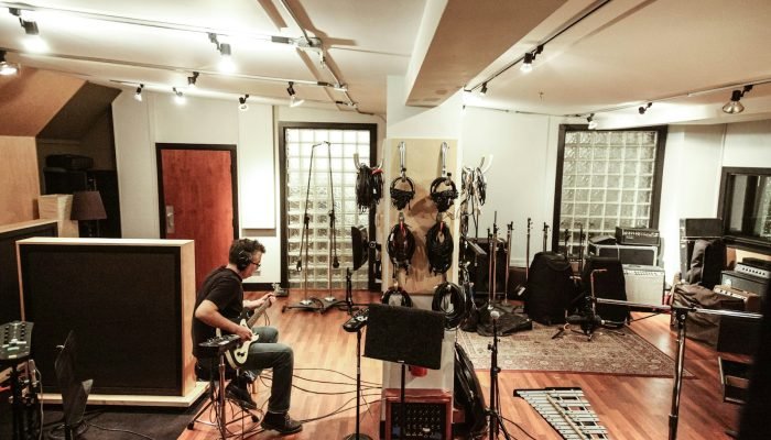 Band rehearsing with instruments in a music studio