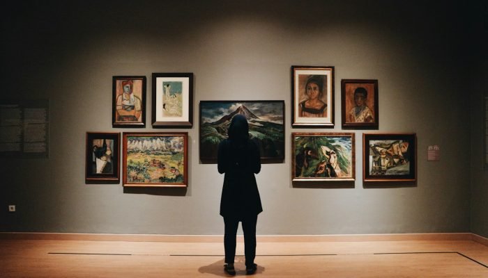 Visitor in front of paintings